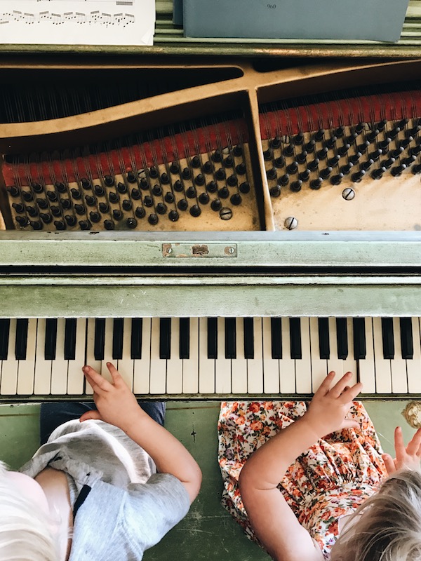 kids playing vintage piano